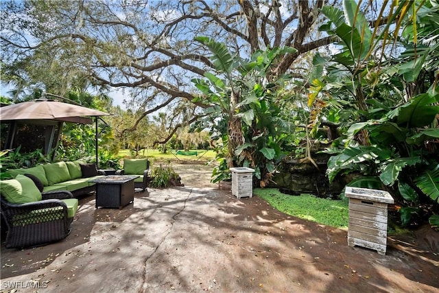 view of patio / terrace featuring an outdoor living space with a fire pit