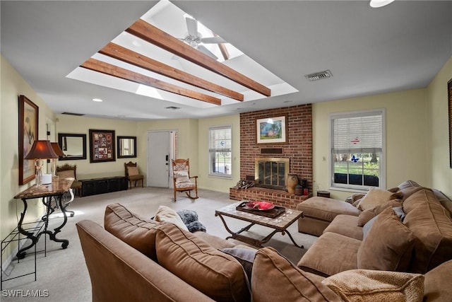 living area with a skylight, plenty of natural light, visible vents, carpet, and a fireplace