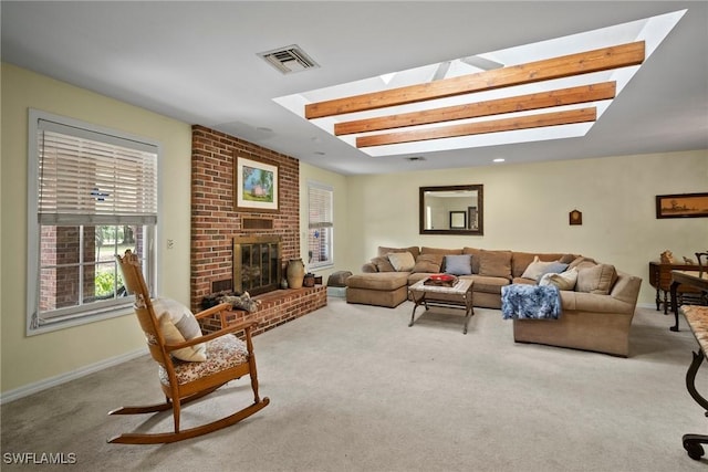 carpeted living area with a skylight, a brick fireplace, visible vents, and baseboards