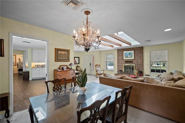 dining space featuring dark wood-style floors, a fireplace, and visible vents