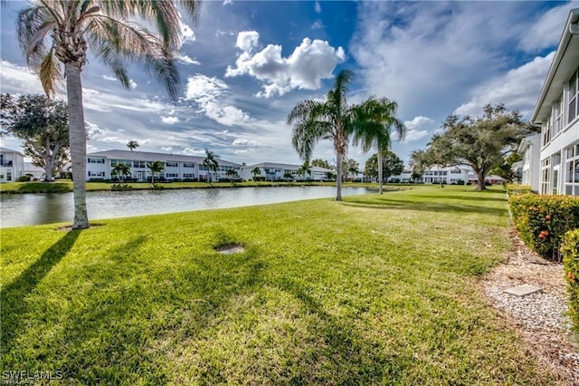 view of yard featuring a residential view and a water view