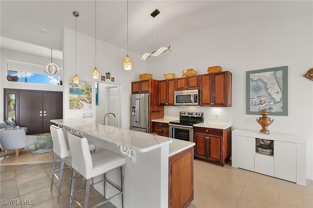 kitchen featuring high vaulted ceiling, light tile patterned floors, and appliances with stainless steel finishes