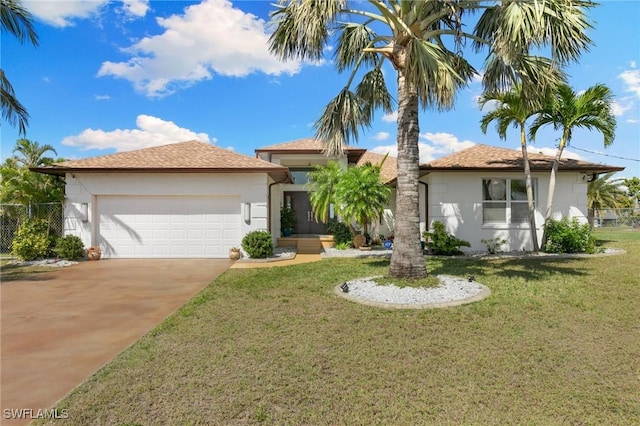 view of front of home with concrete driveway, an attached garage, fence, a front lawn, and stucco siding