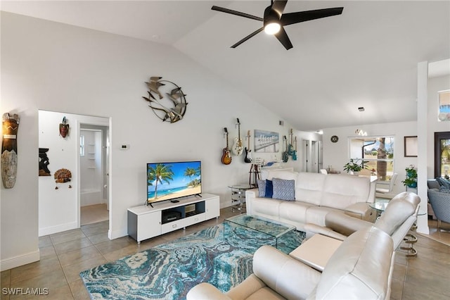 tiled living room featuring ceiling fan, high vaulted ceiling, and baseboards