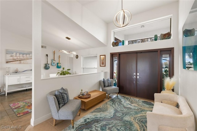 foyer entrance featuring visible vents, a notable chandelier, and tile patterned floors