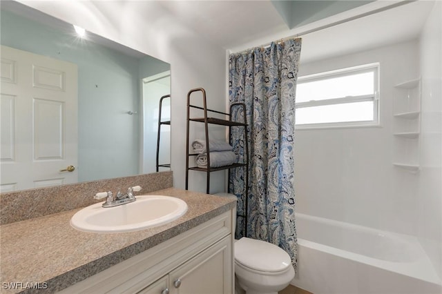 full bath with vanity, shower / bath combo with shower curtain, and toilet