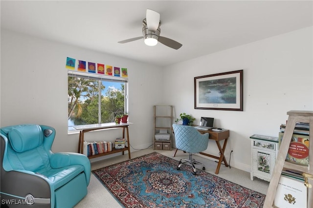 office space featuring a ceiling fan, carpet, and baseboards