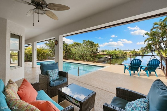 outdoor pool with a patio area, fence, an outdoor hangout area, and a ceiling fan