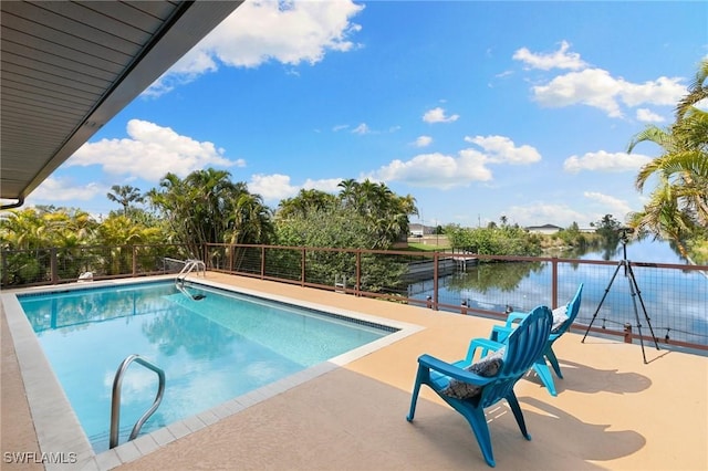 view of swimming pool with a water view and a fenced in pool