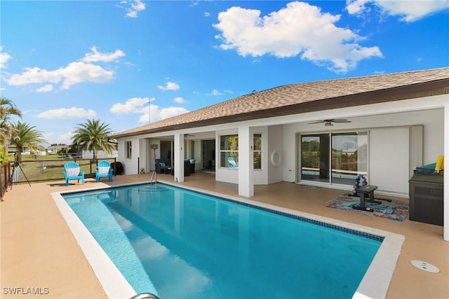 back of property with a fenced in pool, a patio, stucco siding, a shingled roof, and a ceiling fan