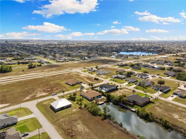 birds eye view of property with a residential view and a water view