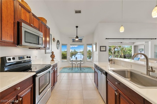 kitchen with light tile patterned floors, visible vents, stainless steel appliances, light countertops, and a sink