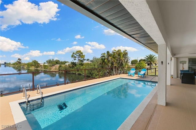 outdoor pool featuring a patio area, a water view, and fence