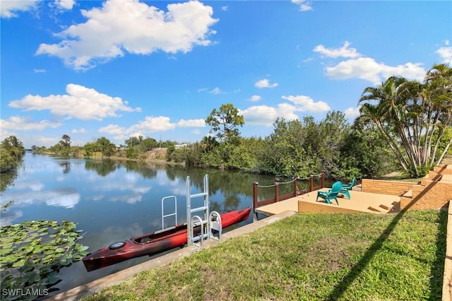 dock area featuring a lawn and a water view