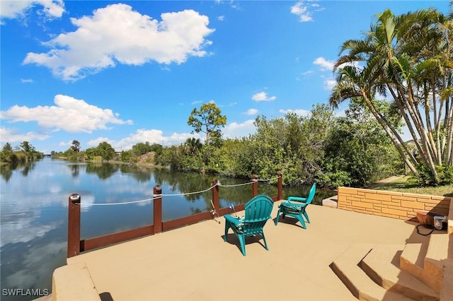 view of dock with a patio area and a water view