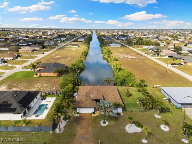 drone / aerial view with a water view and a residential view