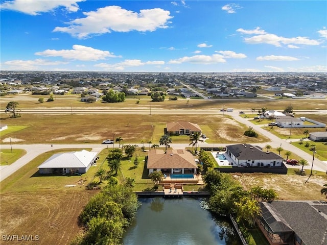 birds eye view of property with a water view and a residential view