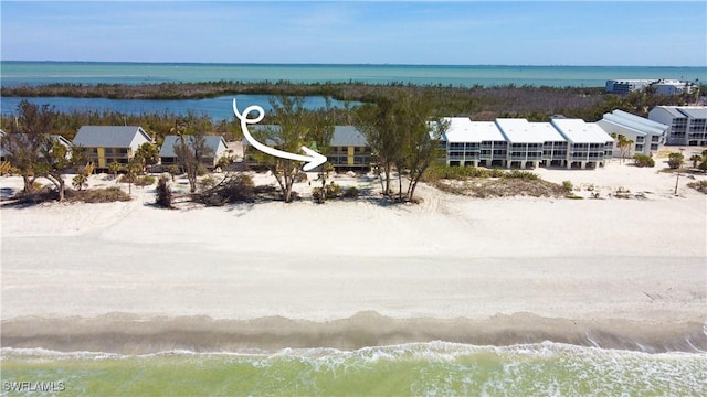 aerial view with a water view and a view of the beach