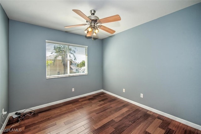 unfurnished room featuring a ceiling fan, baseboards, and dark wood-style flooring