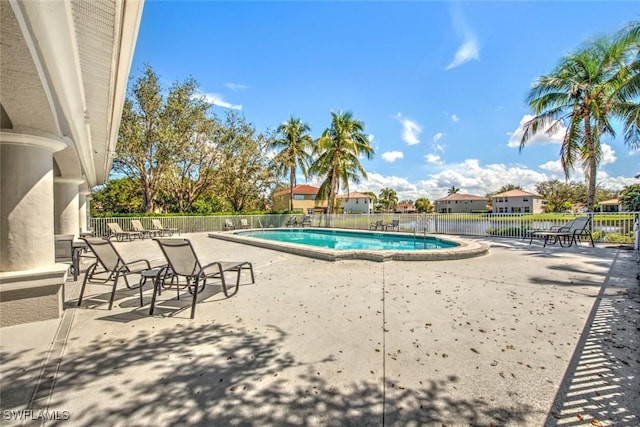 community pool featuring a patio area and fence