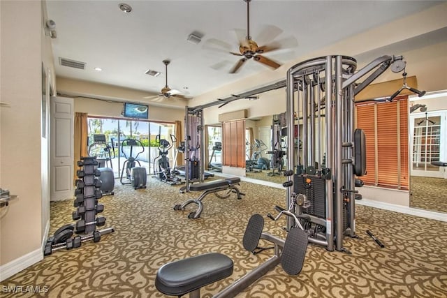 exercise room with carpet, baseboards, visible vents, and ceiling fan