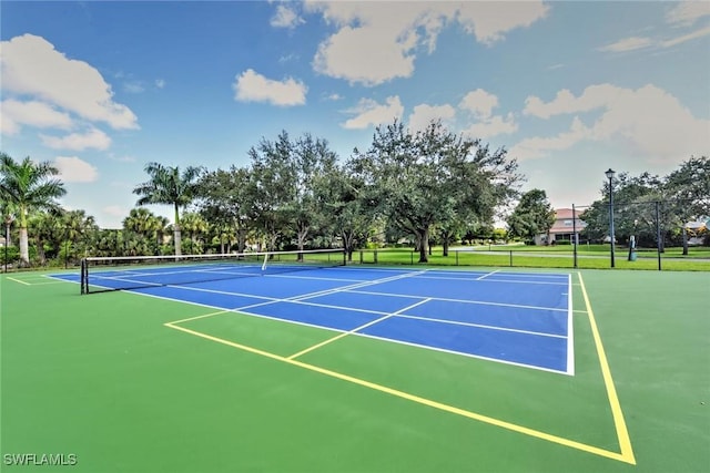 view of tennis court featuring fence