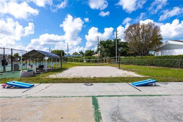 surrounding community featuring fence, a lawn, and volleyball court