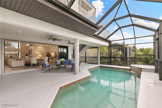 outdoor pool featuring a ceiling fan, a lanai, a patio, and an outdoor living space