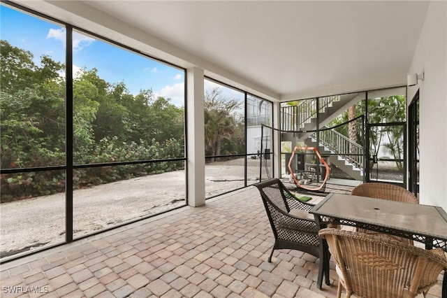 sunroom / solarium featuring outdoor dining space