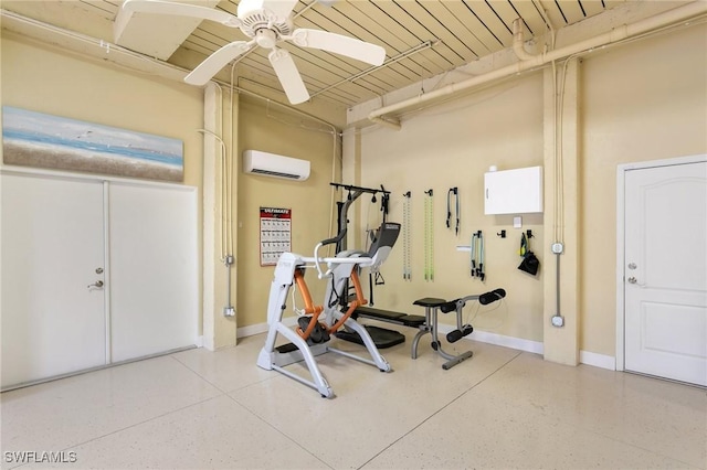 exercise area featuring a wall mounted air conditioner, a ceiling fan, and baseboards