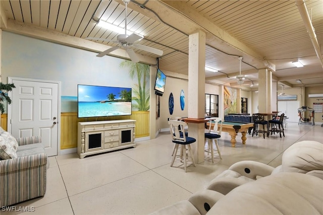 living room with baseboards, beam ceiling, a ceiling fan, and wooden ceiling