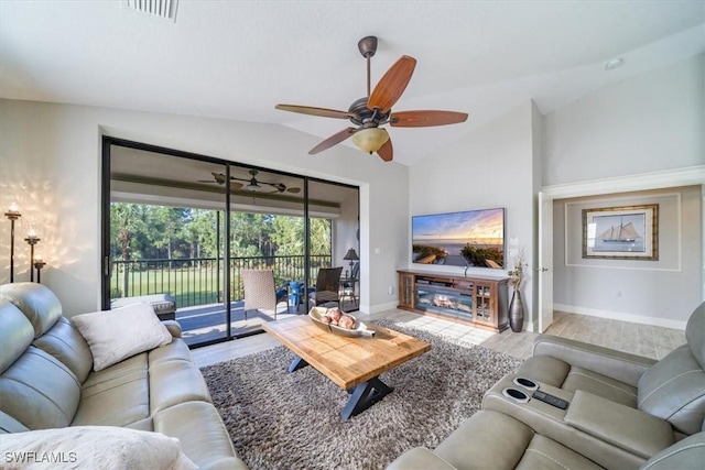 living room featuring ceiling fan, wood finished floors, visible vents, baseboards, and vaulted ceiling