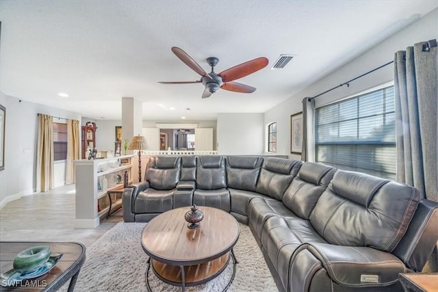 living room featuring visible vents, baseboards, light wood-style flooring, ceiling fan, and recessed lighting