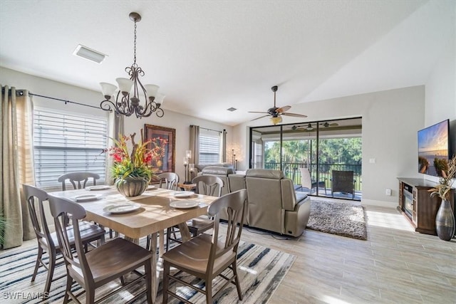 dining room with light wood finished floors, baseboards, visible vents, lofted ceiling, and ceiling fan with notable chandelier