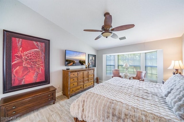 bedroom with baseboards, visible vents, a ceiling fan, wood finished floors, and vaulted ceiling