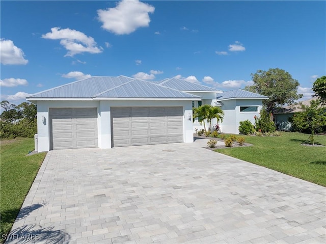 single story home featuring stucco siding, a front lawn, a garage, decorative driveway, and metal roof