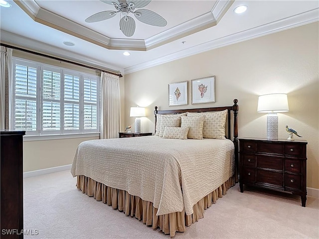 bedroom featuring baseboards, a tray ceiling, ornamental molding, and light colored carpet