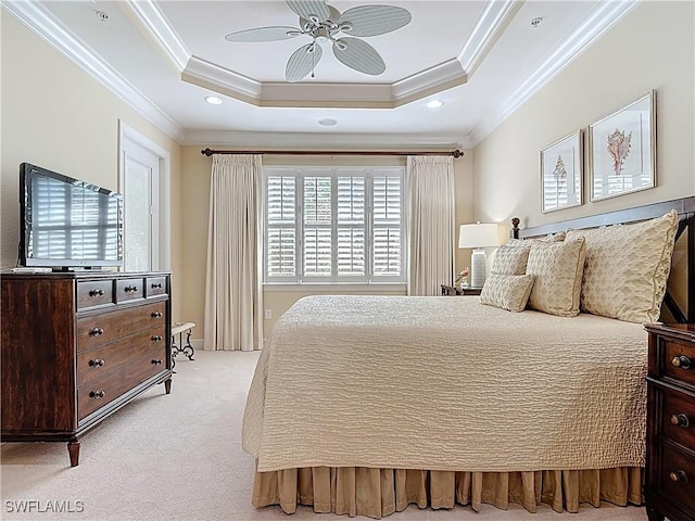 bedroom featuring light carpet, a ceiling fan, a tray ceiling, crown molding, and recessed lighting