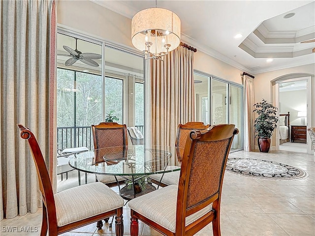 dining area with arched walkways, tile patterned flooring, ceiling fan with notable chandelier, crown molding, and recessed lighting