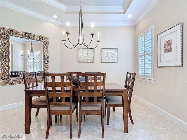 dining room featuring a chandelier, ornamental molding, a raised ceiling, and baseboards