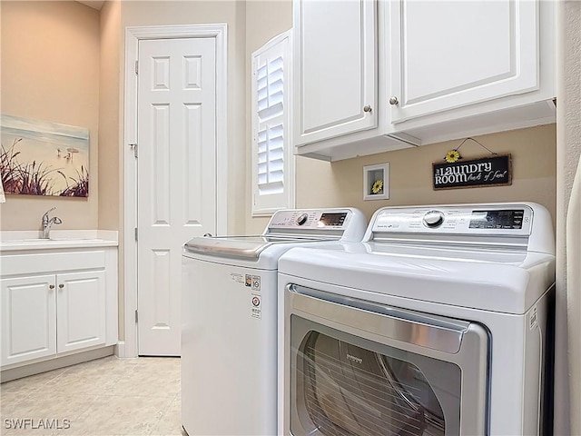 laundry room featuring washer and dryer, cabinet space, a sink, and light tile patterned floors