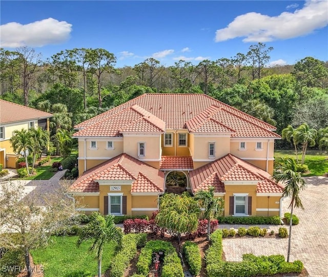 mediterranean / spanish-style house featuring a tile roof and stucco siding