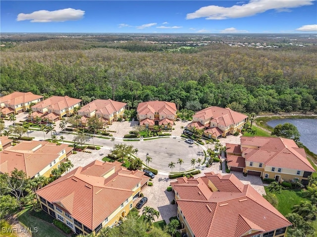 bird's eye view with a water view, a wooded view, and a residential view