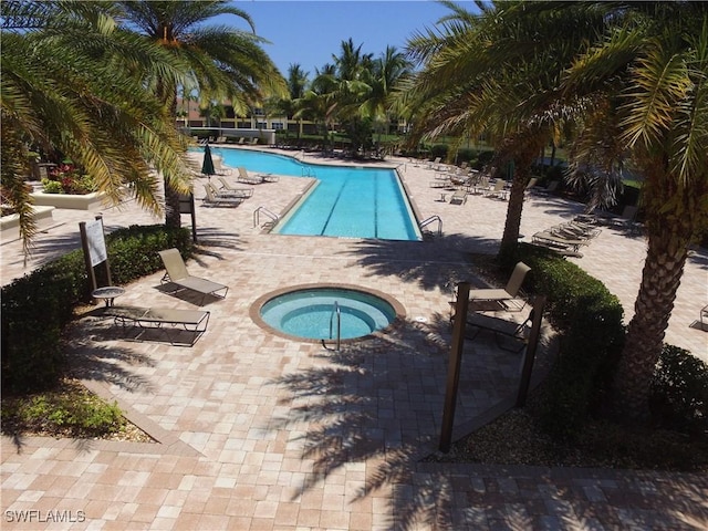 community pool with a patio and a community hot tub