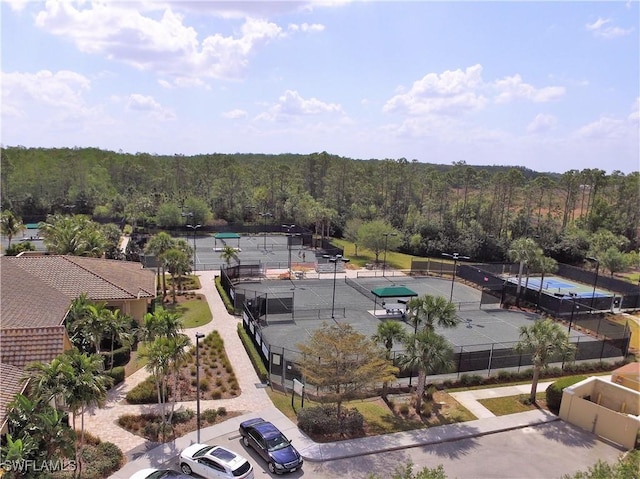 drone / aerial view with a wooded view