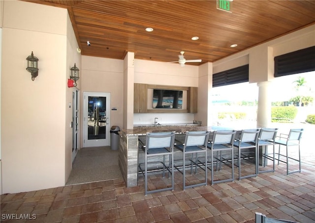 kitchen with wood ceiling, a breakfast bar area, and recessed lighting