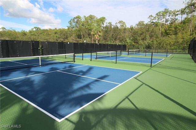 view of tennis court with fence