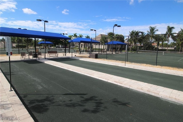 view of home's community featuring fence