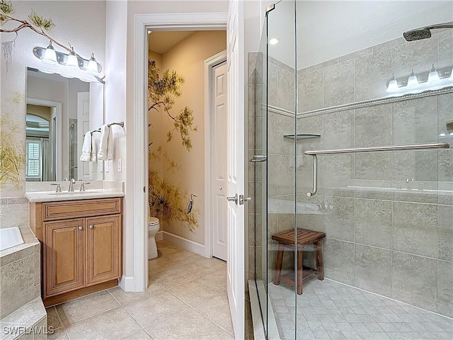 full bathroom with baseboards, toilet, tile patterned flooring, vanity, and a shower stall