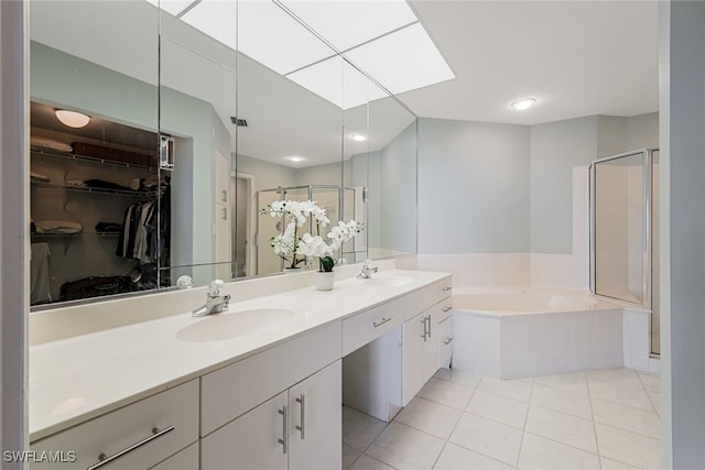 full bath featuring a garden tub, double vanity, a sink, and a shower stall